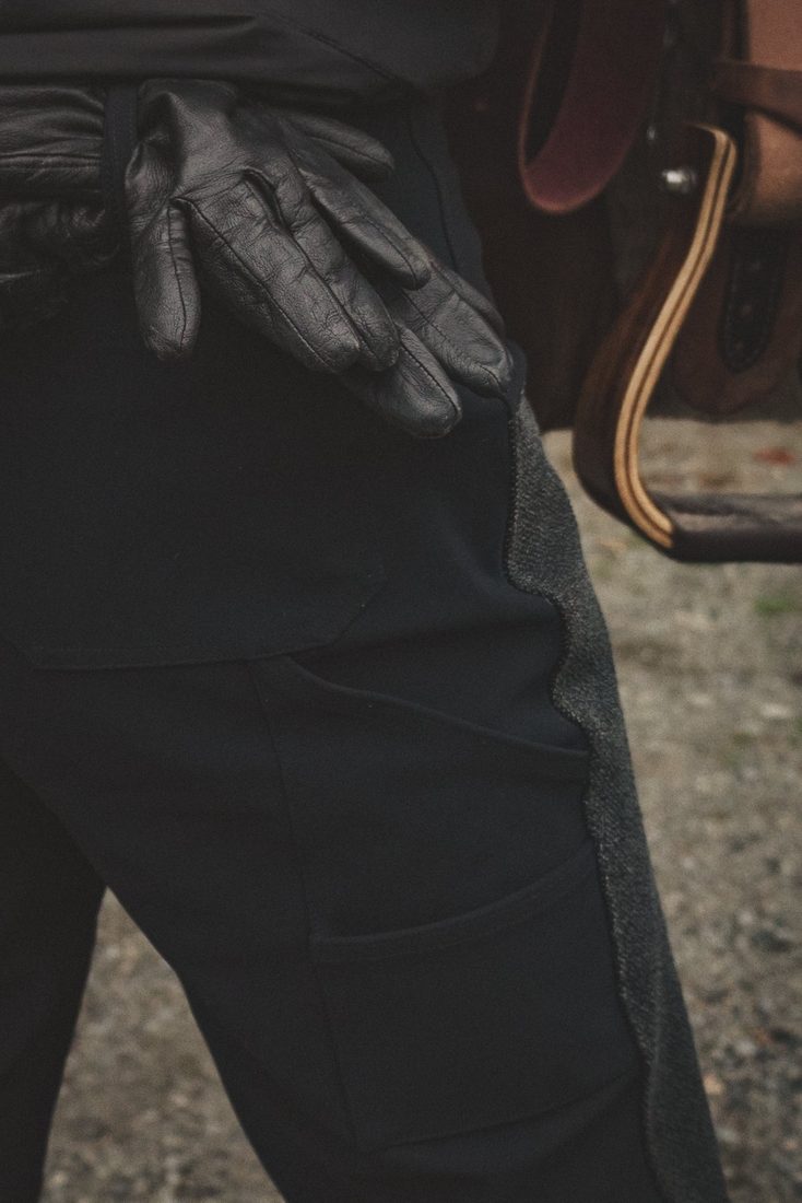 Leather gloves tucked into the Hackmore utility belt loop on the back hip